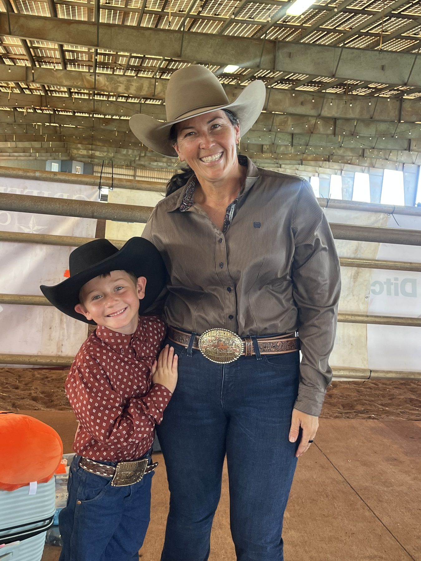 Mom and son in cowboy hats at the ranch